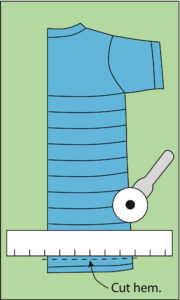 illustration showing a ruler and a rotary cutter making lines across a folded t-shirt